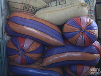 Bags filled with dried coffee seeds are stored in a Huila warehouse