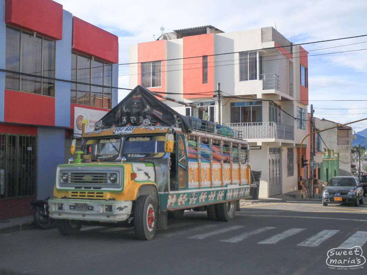 Colorful bags of coffee can be seen almost spilling out of this colorful chiva bus in Buesaco town.