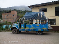 An older Chiva bus parked in the Aponte town square a few doors down from the association we buy coffee from.