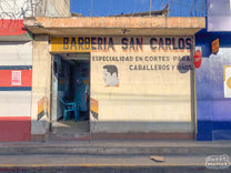 Hand-painted "Barberia" ("barber") sign along the road to Tecpán in Chimaltenango.