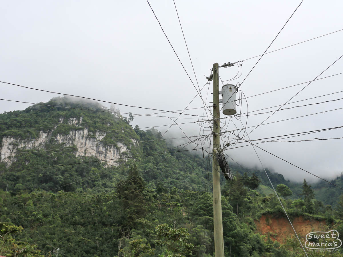 A web of power lines stretch from a tall line poll in La Libertad, near Peña Blana.