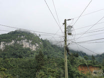 A web of power lines stretch from a tall line poll in La Libertad, near Peña Blana.