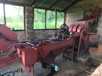 The red disc pulper at the Fram Farm coffee site that is used to remove the outer cherry from the green coffee seeds.