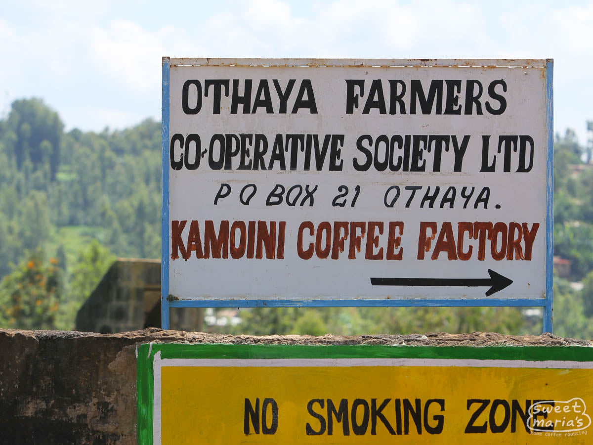 The hand painted sign marking the entrance to the Kamoini coffee factory where all of the green coffee from cooperative members is processed. Nyeri, Kenya.
