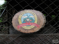 A wooden sign reads "Cafetalera Buenos Aires" as you enter the farm.