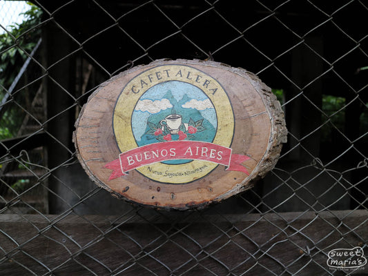 A wooden sign reads 