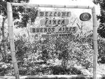 One of the wooden welcome signs marking the entrance to the Buenos Aires farm.