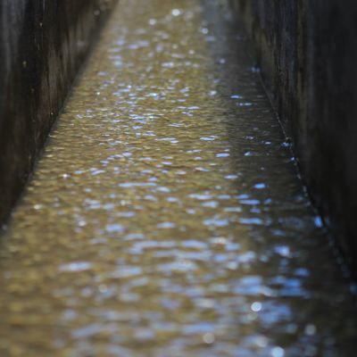 Rippling water in the cement washing channel at a wet mill in Huehuetenango, Guatemala.