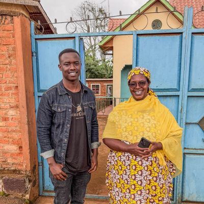 Owner Beathe on the right, and her son Sam on the left, in front of the gate to Mushaka Station in Rusizi, Rwanda.