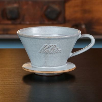 The Kalita MINO Ceramic Dripper comes in a cool, bluish "Sand Gray" colorway.