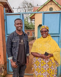 Owner Beathe on the right, and her son Sam on the left, in front of the gate to Mushaka Station in Rusizi, Rwanda.